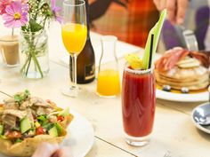 a person sitting at a table with food and drinks