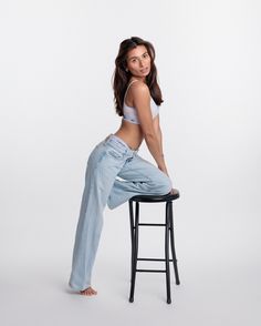 a woman sitting on top of a stool