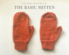 an orange knitted mitten sitting on top of a white sheet with the words, the basic mitten written below it