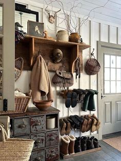 a bunch of shoes are hanging on the wall in a room with shelves and baskets