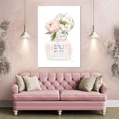 a pink couch sitting in front of a wall with flowers on it and a quote