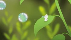 an animated image of bubbles floating in the air next to a green leafy plant