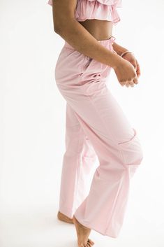 Introducing the epitome of style and functionality: our Colby nylon pocketed pants. Designed for the modern woman on the move, these pants combine fashion-forward flair with practicality. Whether you're running errands or lounging at home, these pants provide the perfect balance of versatility and comfort. The perfect blend of fashion and function. Pair them with our Colby Nylon Tube Top for the most perfect set of the season! Size Chart Features: relaxed fit high rise drawstring waist﻿ pockets fabric content: 100% nlyon model is 5'9" and wearing a small bust: 32B waist: 24" hip: 34" Denim Accessories, Pocket Pants, Dress Romper, Small Bust, Tube Top, Bottoms Pants, Short Tops, Modern Woman, Running Errands