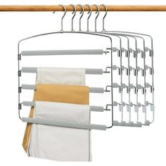 an over the door drying rack holds six folded towels and two pairs of hanging pants