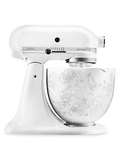 an artisan stand mixer with white floral design on it's front and side