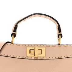 This is an authentic FENDI Cuoio Romano Selleria Chamois Small Peekaboo I SEE U Satchel in Rosa Plaster. This handmade tote is crafted of light pink grained calfskin leather with prominent hand stitching in off-white. The bag features a leather top handle, an optional shoulder strap, and a gold tone turn-lock on either side that opens the bag to a partitioned taupe microfiber interior with a patch pocket. Handmade Tote, Leather Top, Hand Stitching, Patch Pocket, Top Handle, Calf Skin, Light Pink, Satchel, Fendi