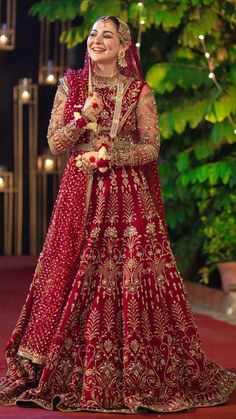 a woman in a red and gold bridal gown