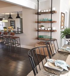 the dining room table is set with place settings and plates on it, along with other furniture