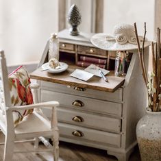 a chair and desk in a room with wooden floors, white walls and wood trimmings