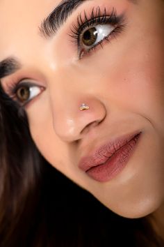 a close up of a woman's face with long eyelashes