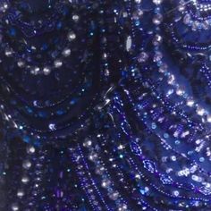 a close up view of beads on a dress