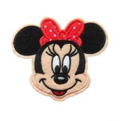 a minnie mouse patch with a red bow on it's head