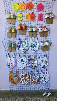 a bulletin board with sandals and paper cutouts on it, hanging from the wall