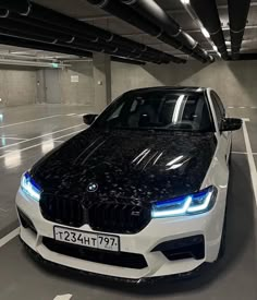 a white and black car parked in a parking garage