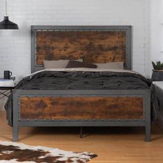 a bed that is made up with wood and metal