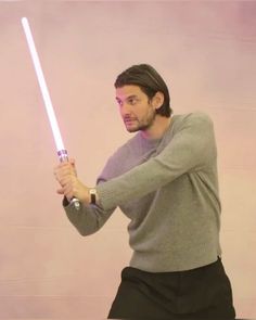 a man holding a light saber in his right hand