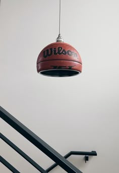 a basketball hanging from the ceiling next to some stairs