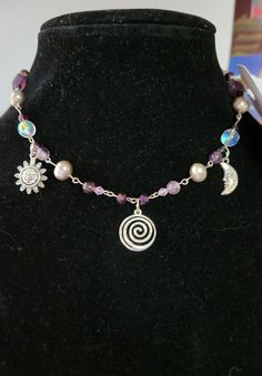 Add a touch of celestial magic to your style with our Whimsical Sun and Moon Beaded Crystal Necklace. It's perfect for casual wear or special occasions. Embrace enchantment and elevate your look effortlessly! Adjustable Magical Jewelry With Sun And Moon Design, Adjustable Magical Sun And Moon Jewelry, Adjustable Magical Moon Phase Jewelry, Bohemian Jewelry With Moon Charm And Round Beads, Adjustable Purple Moon Phase Jewelry, Adjustable Bohemian Beaded Necklace With Moon Charm, Purple Bohemian Jewelry With Moon Charm, Bohemian Purple Jewelry With Moon Charm, Adjustable Mystical Necklace With Gemstone Beads