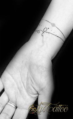 a woman's hand with a small tattoo on the wrist and an arrow in the middle