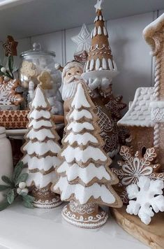 some christmas trees and other decorations on a shelf