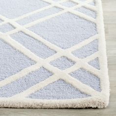 a blue and white rug on the floor with lines drawn across it's surface