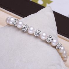 This beautiful Freshwater pearl bracelet ranges between 7-8mm in size and consists of beautiful and lustrous pearls in AAAA+ quality. All pearls in this bracelet are round and are strung with silk thread and double-knotted between each pearl. Known as the 'icon' of cultured pearls, Freshwater pearls have graced the necks, ears, fingers, and wrists of women for decades. Huge Tomato imports their Freshwater pearls from the Freshwater rs of Japan, grown in the Pinctada fucata oyster. All of our Fre Pearl White Beaded Round Pearl Bracelet, Beaded Pearl White Round Bracelet, Elegant Crystal Bracelet With 8mm Beads, Pearl Bracelet With 8mm Beads, Pearl White Bracelets With 8mm Pearl Beads, Pearl Beaded Bracelets With 8mm Beads, Round Pearl Crystal Bracelet For Gift, Pearl Bracelet With 8mm Round Beads For Wedding, Pearl White Beaded Bracelet With Pearl Charm