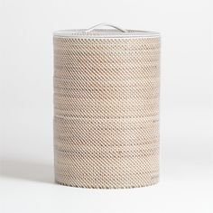 a round woven basket is shown on a white background, with the lid open to reveal an empty container