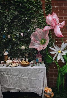 there is a table with food and flowers on it