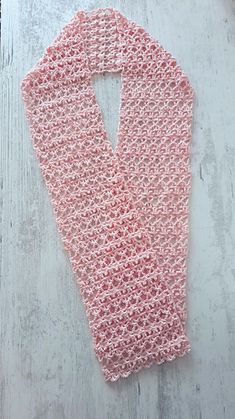 a pink scarf laying on top of a wooden floor