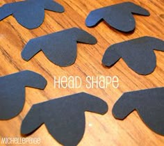 several pieces of black paper cut into shapes