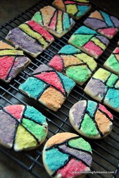 some colorful cookies are on a cooling rack