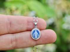 Introducing our exquisitely crafted Very Small and Dainty Miraculous Medal Sterling Silver 925 Rhodium Plated Cameo Pendant! This elegant pendant features a 14 x 12 mm large design made from two parts: a sterling silver frame and a beautiful blue agate paste centerpiece adorned with an image of the Virgin Mary. The front of the medal bears the inscription in French, O Mary conceived without original sin pray for us who appeal to thee, while the back showcases 12 stars, a cross with a capital letter 'M', and depictions of the Immaculate Heart and Sacred Heart. This unique piece can be purchased as a pendant alone or with a chain, making it a perfect accessory for any outfit. Add a touch of grace and devotion to your look with this remarkable Miraculous Medal pendant! Elegant Pendant, Miraculous Medal, Cameo Pendant, Blue Agate, Silver Frame, Virgin Mary, Bosnia And Herzegovina, Beautiful Blue, Rhodium Plated