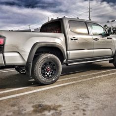 a silver truck parked in a parking lot