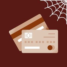 two credit cards are next to a spider web on a brown background with white lines