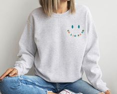 Step into the exclusive world of motherhood style with our Cool Moms Club Sweatshirt – the perfect Mother's Day and Birthday Gift for the trendsetting mom in your life. This stylish and comfortable Cool Mom Sweatshirt is more than just apparel; it's an invitation to join the ranks of the coolest moms around. Crafted with care and flair, our Smiley Face Sweatshirt adds a touch of playfulness to the cozy warmth of this sweatshirt. Whether it's a casual day out or a special occasion, this Mama Swea Smiley Face Sweatshirt, Face Sweating, Cool Moms Club, Trendy Mom, Club Sweatshirts, Stylish Mom, Moms Club, Cool Mom, Mama Sweatshirt