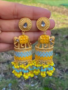 Elephant statement earrings available in 3 colors- navy blue- baby blue/ baby pink- mint green/ yellow- ferozi(blue) Style tip- ----------- Pair it with any beautiful traditional outfits  and flaunt with Unique style of collection from us. Perfect match for Festival and Traditional wear.  Take Care Tips-  ---------------- Kee away from perfume, Hair spray and. Moisture.  Store in dry place , Ziplock bag or Airtight box.    Clean with dry cloth.  Jewellery is the last thing you should wear and fi Blue Temple Jewelry Jhumkas Gift, Turquoise Kundan Earrings For Festivals, Handmade Yellow Bollywood Jewelry, Blue Tilla Jhumkas For Gift, Handmade Blue Danglers For Wedding, Turquoise Earrings For Festive Occasions, Festive Turquoise Earrings As Gift, Festive Turquoise Earrings For Gift, Bollywood Style Turquoise Earrings For Gift