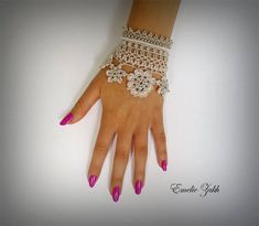 a woman's hand with pink and white manicures on her left wrist