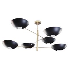 a black and gold chandelier with five lights on it's sides,