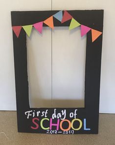 the first day of school frame is decorated with colorful flags