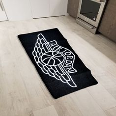 a kitchen area with an oven and rug on the floor