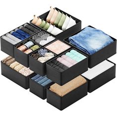 the drawers are organized with folded towels and scarves in black fabric, which is also filled with socks