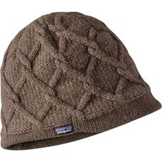 the patagon cable beanie is made from wool and features a large braiding pattern