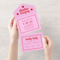 someone holding up two pink business cards with red writing on them that read valentine's giveaway