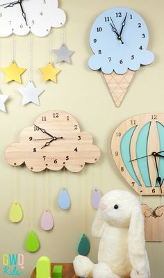 a wooden clock with an ice cream cone and hot air balloon hanging from it's side