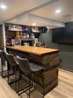 a home bar with stools in the corner