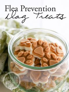 a glass jar filled with heart shaped marshmallows on top of a table