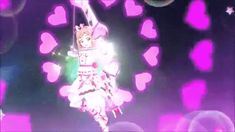 a person on a stage with lights in the background and hearts all around her body