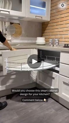 a man standing in front of a kitchen counter next to a sink and oven with the words would you choose this smart cabinet design for your kitchen?