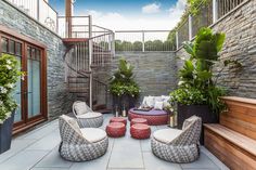 an outdoor patio with seating and potted plants