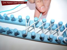 a person is weaving yarn on a blue object